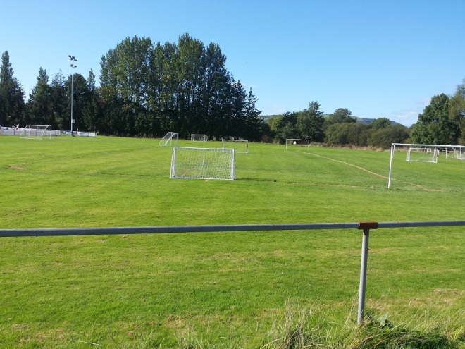 Playing fields between the small stand and entrance